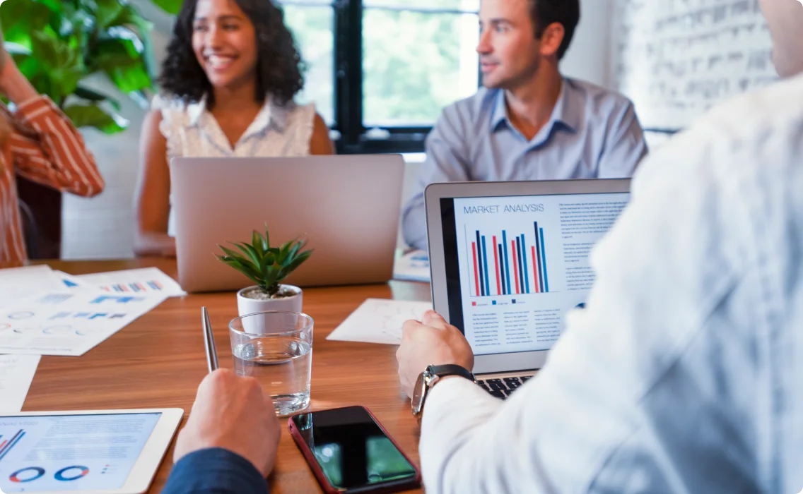 A man and women smiling in a conference room