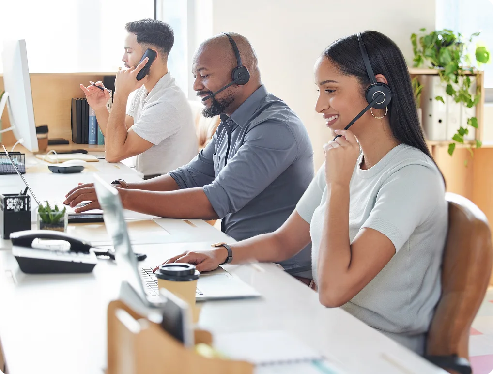 Customer service team with headsets providing support at their workstations.