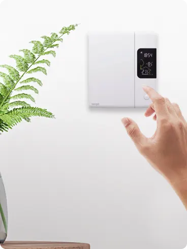 A hand adjusts a Sensi thermostat.