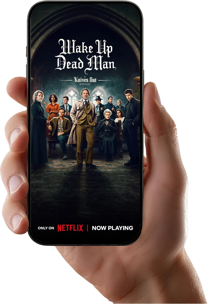 A hand holds a smartphone with the screen displaying Netflix’s film Wake Up Dead Man.