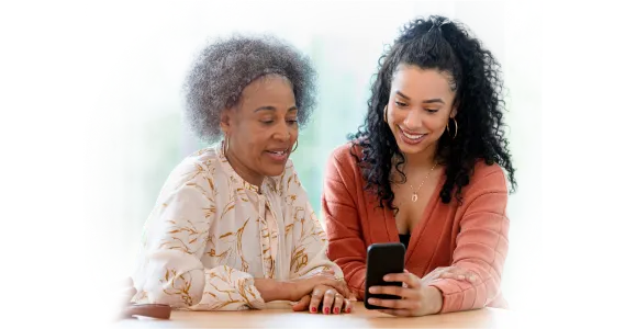 Two women viewing a smartphone together