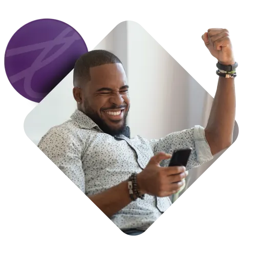 A smiling man holding a phone with an arm raised in celebration, with the Purple TELUS Rewards logo to the right.