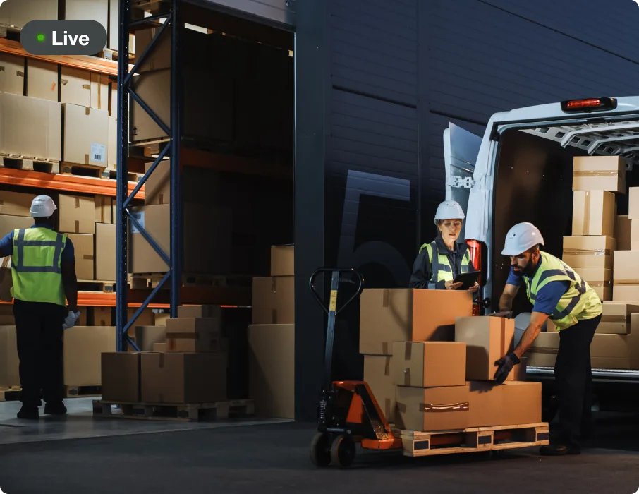Live camera view of a team loading boxes at a warehouse dock