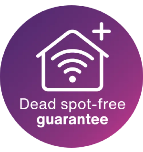 A roundel with an icon of a Wi-Fi symbol within a house. The text below it says: Dead spot-free guarantee.