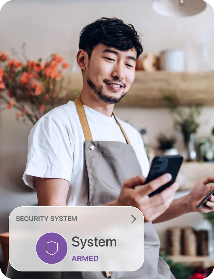 A man on his phone arming his security for his workplace