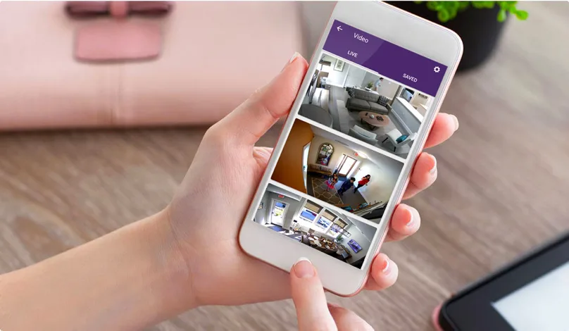 User checks rooms monitored by TELUS smart home security cameras on mobile.