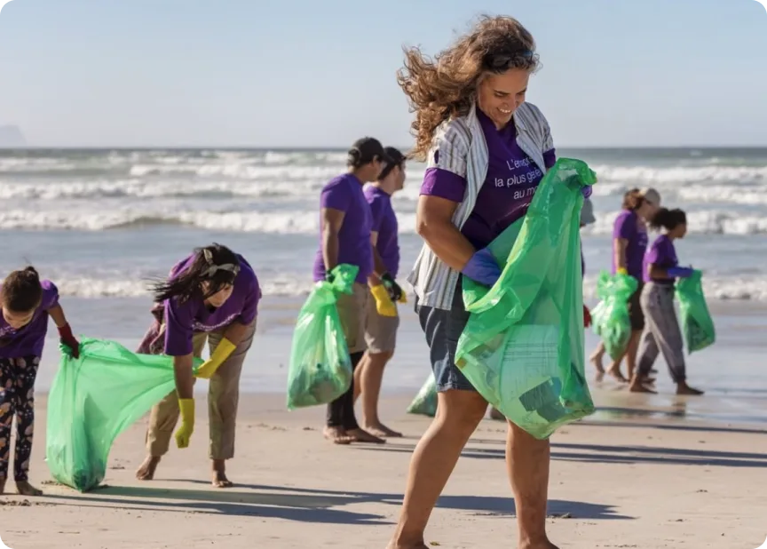 TELUS team members cleaning a shoreline. 