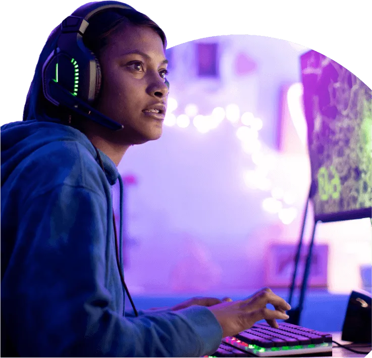 An image showing a girl wearing her headphones playing on a computer.
