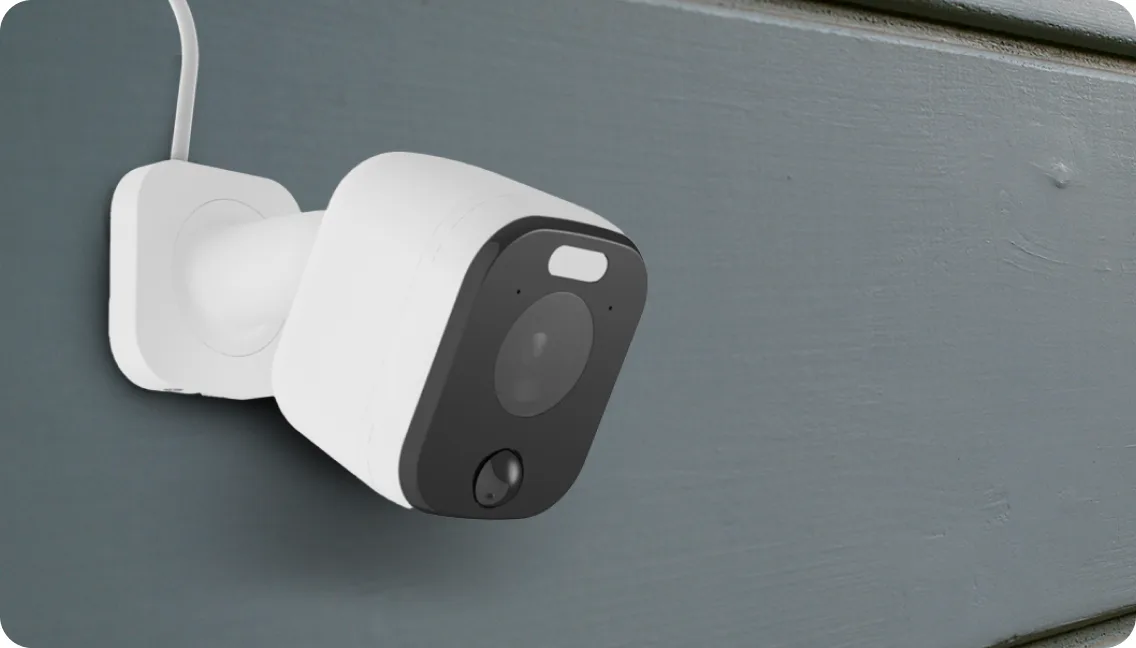 A TELUS Outdoor Camera is installed on the side of a home. 