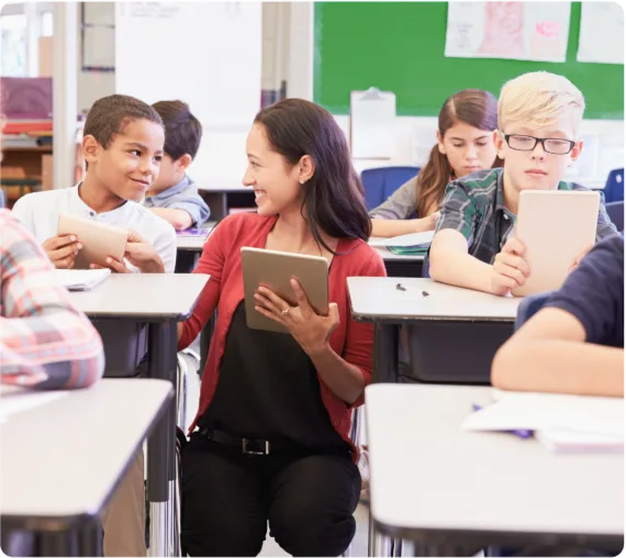 A teacher interacting with a classroom full of students with tablets