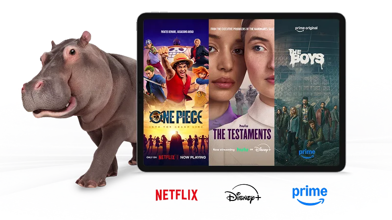 A hippo standing next to a tablet displaying the posters of One Piece, The Testaments and The Boys.