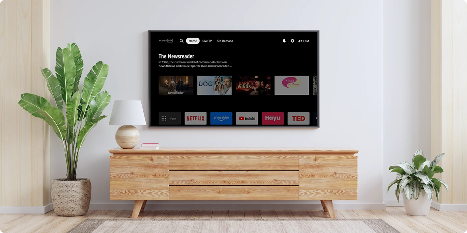 Modern living room with a wall-mounted TV displaying Stream+ interface featuring Netflix, Prime Video and other apps.