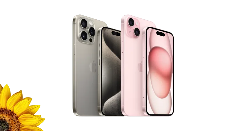 Front and back views of the iPhone 15 Pro in Natural Titanium and the iPhone 15 in Pink. A vibrant sunflower is peeking out from the bottom-left corner. 