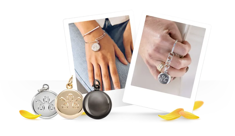 A close up of an individual’s hand holding a stylish SmartWear Security device.