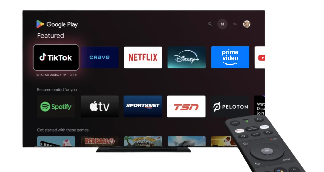 A large smart TV with various streaming apps displayed on screen with a smart TV remote pointing towards it