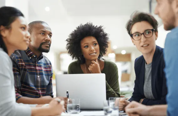 A small group of employees in a meeting