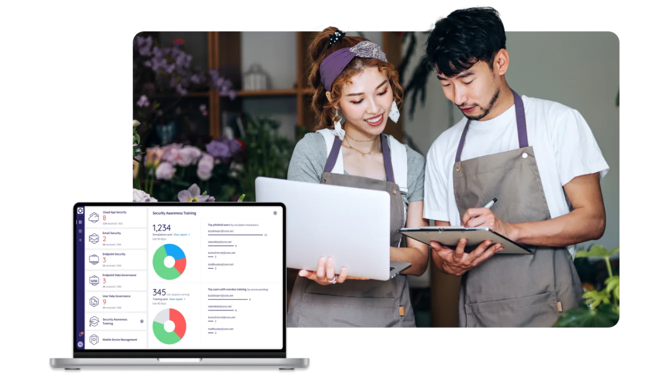 Business partners looking at iPad and laptop. Laptop with data shown