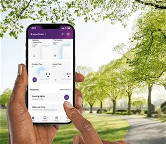 A hand holding a smartphone, controlling their SmartEnergy devices through the SmartHome+ app.