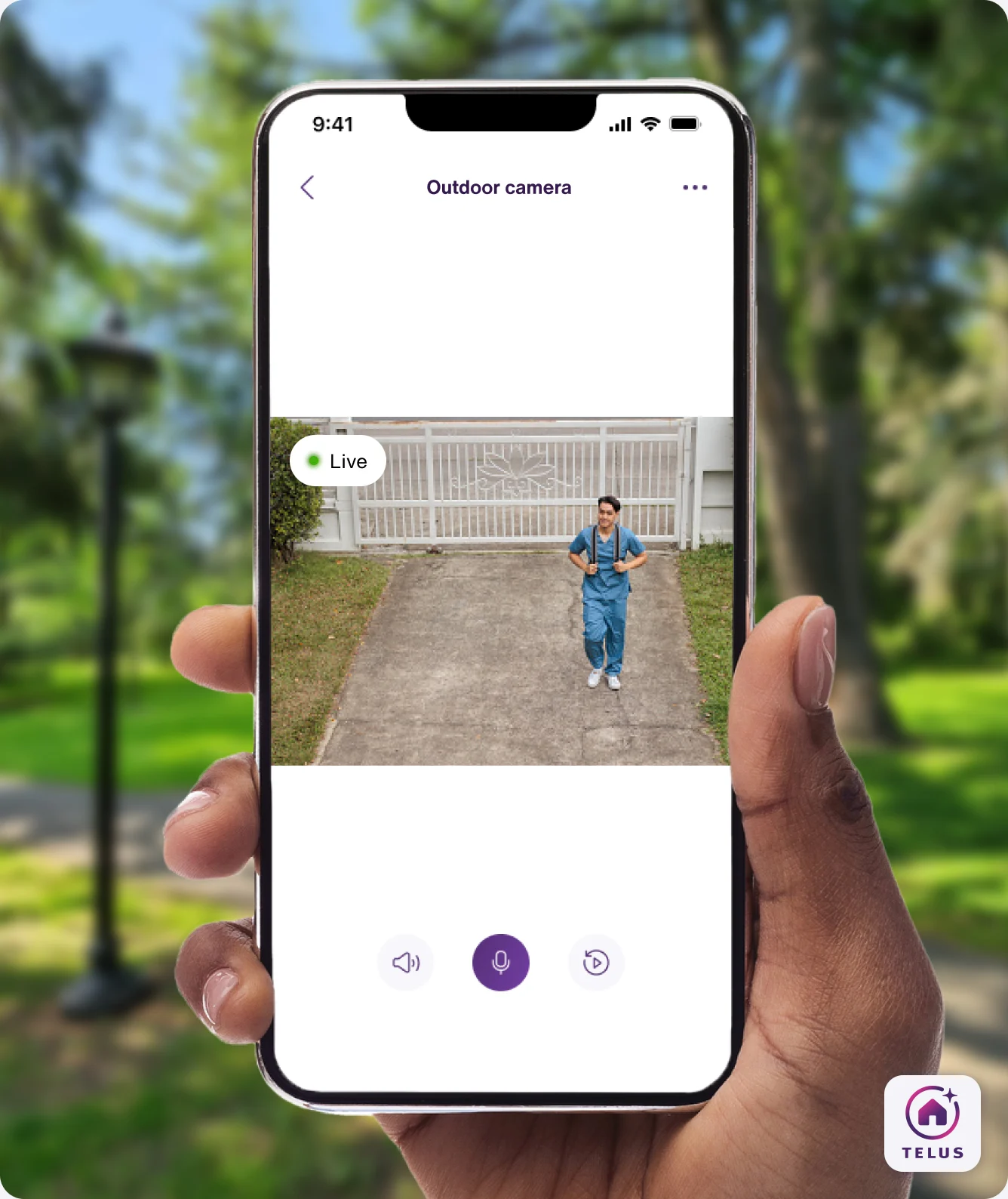 A hand holding the TELUS SmartHome+ app showing a visitor to the house from the view of a TELUS Outdoor Camera. 