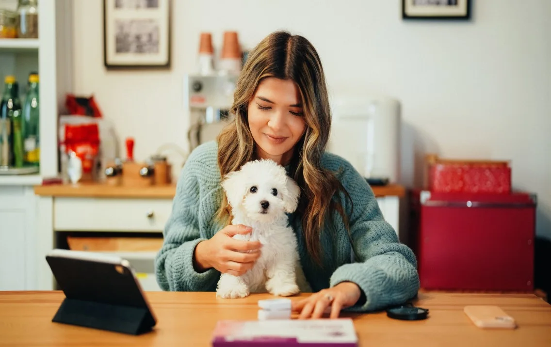 Woman and her dog looking at a tablet