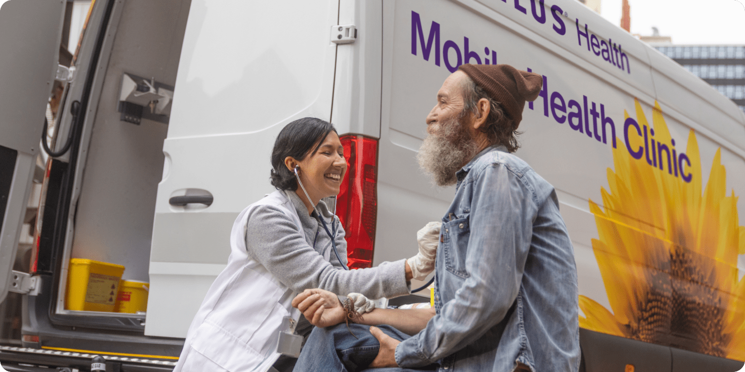 A TELUS Mobile Health Clinic team member attending to a patient