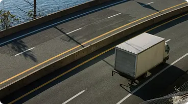 Delivery truck driving on multi-lane highway.