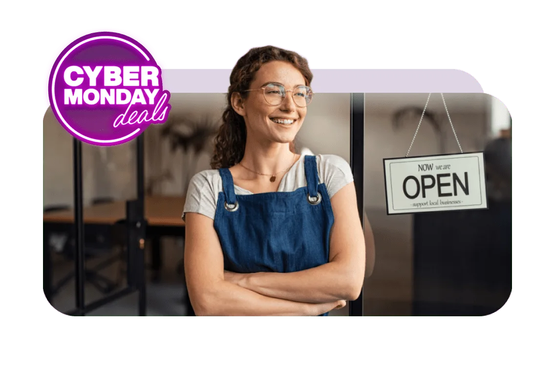 A purple sticker that says ”Cyber Monday deals” next to a woman in front of a store with a sign that says ”Now we are open - support local businesses”.