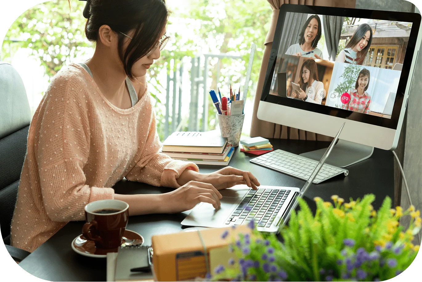 A woman sitting at her desk and working off her laptop.