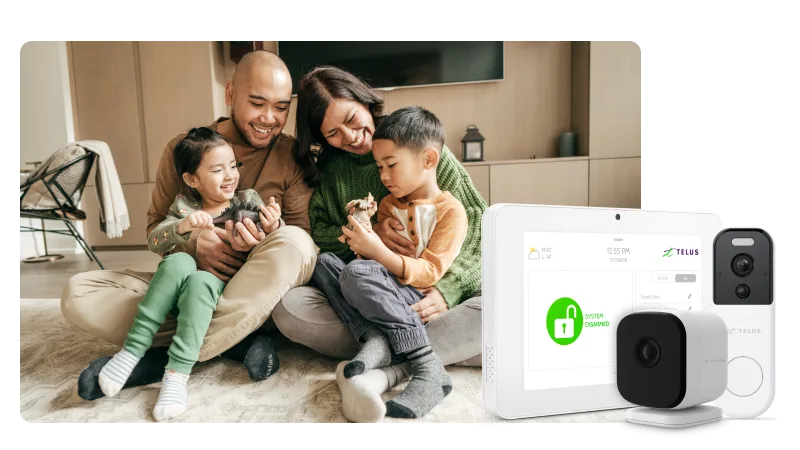 A happy family sits together on the floor next to TELUS home security devices and a control panel.