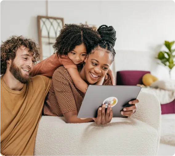 Two adults and a child viewing a tablet