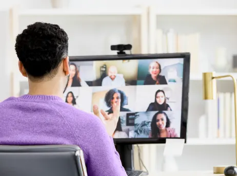 Employee participating in a virtual meeting on a computer with a fast fiber optic internet connection.