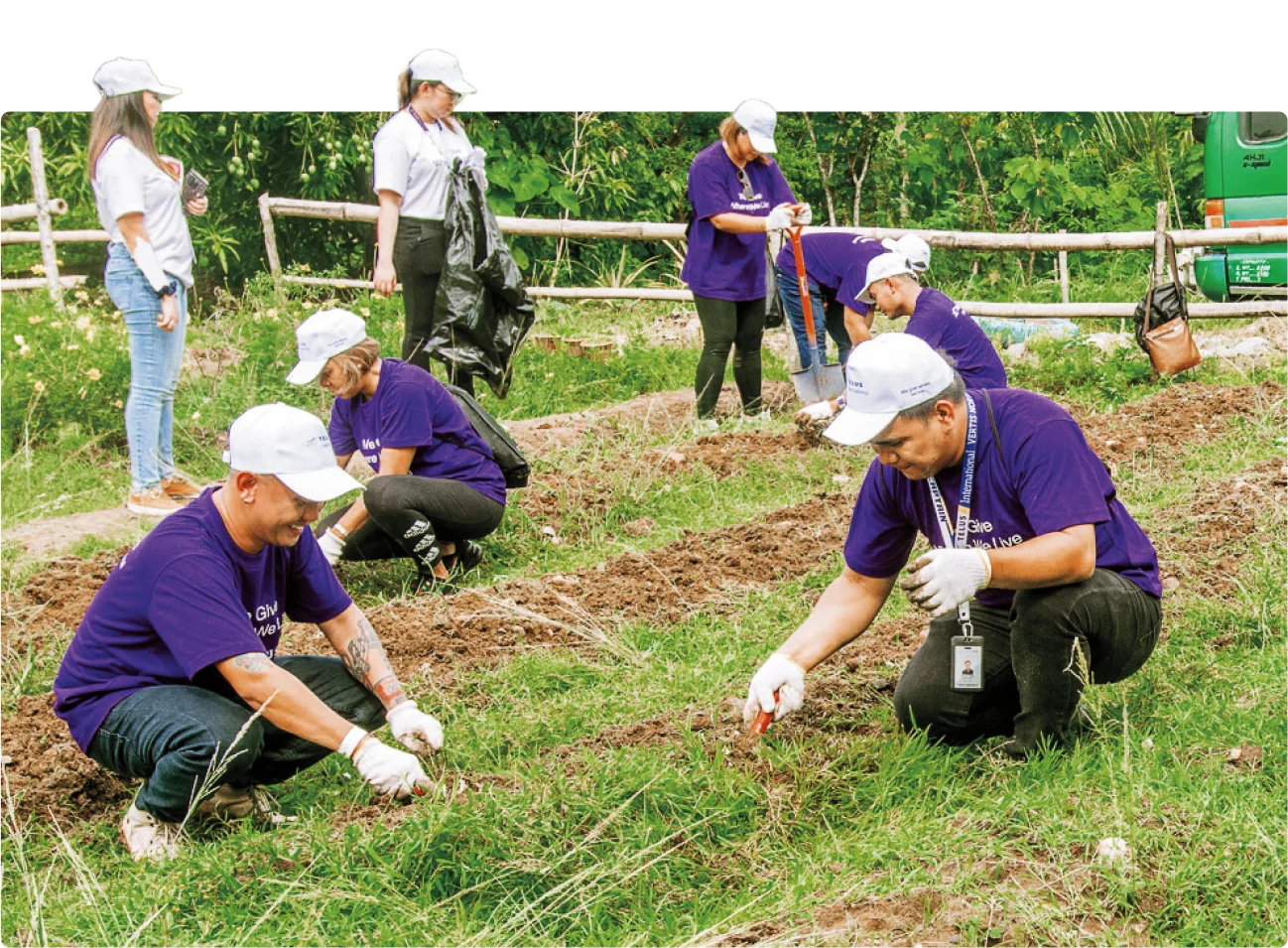 TELUS International team members preparing soil in a community garden in New Lucena.