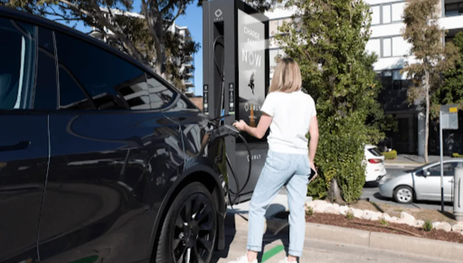 A person charging their car at a JOLT electric vehicle charging station.