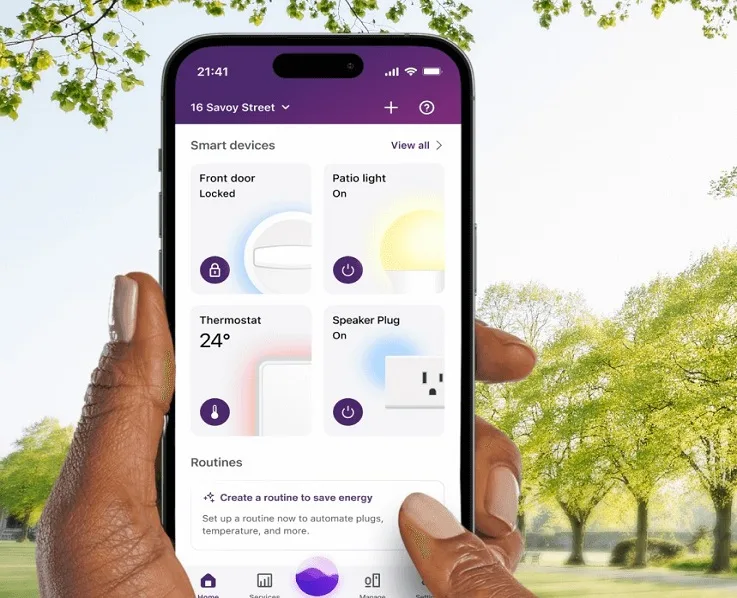 Hand holding smartphone showing energy management app interface