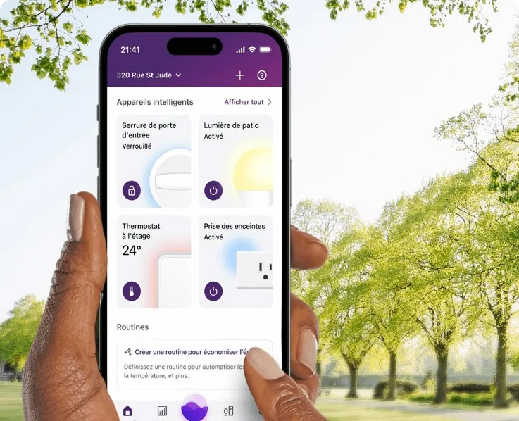 Une main tient un téléphone intelligent montrant l’interface de l’application de gestion de l’énergie