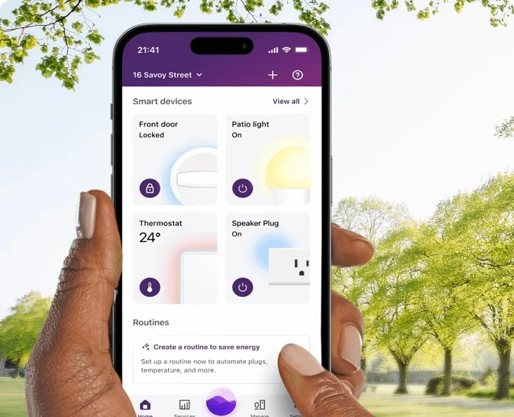 Hand holding smartphone showing energy management app interface