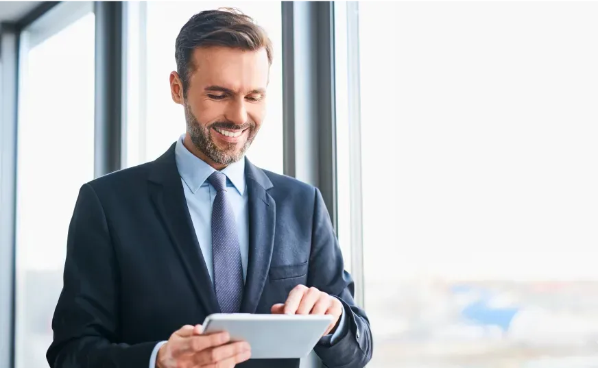 Une image montrant un homme utilisant sa tablette dans un bureau.