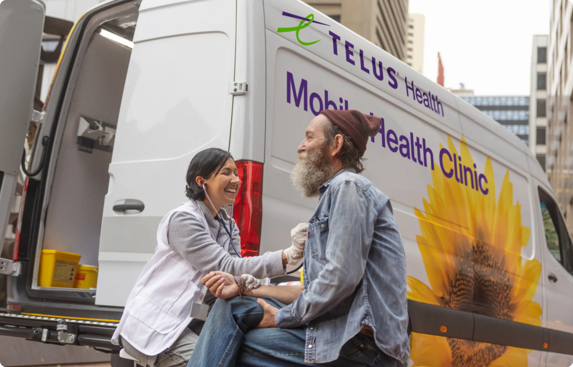 A TELUS Health for Good Mobile Clinic team member treating a patient