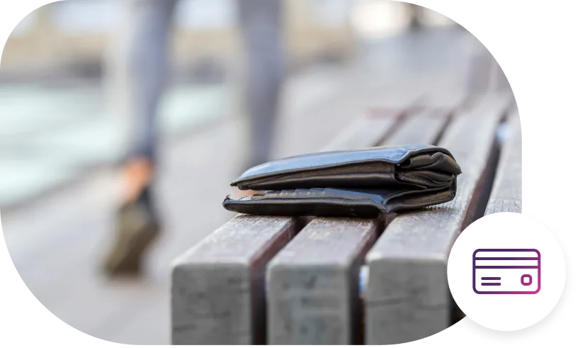 A wallet sitting on a boardwalk park bench.