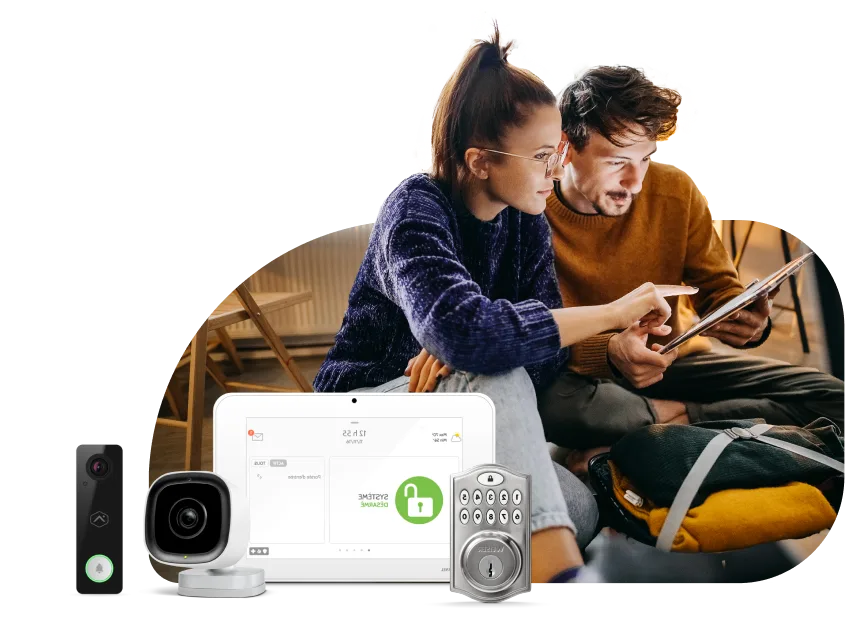 An image showing a couple happily browsing their tablet with SmartHome security products on the foreground.