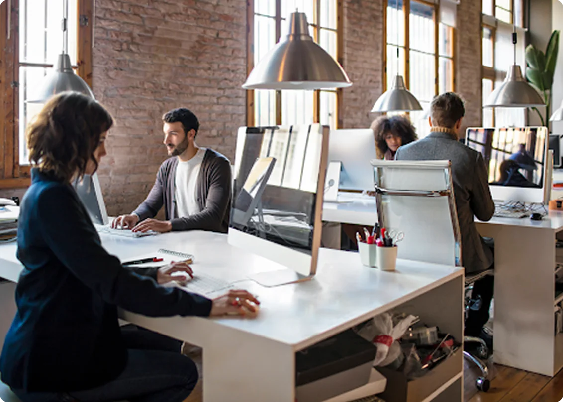 Business team working collaboratively in modern open office space.
