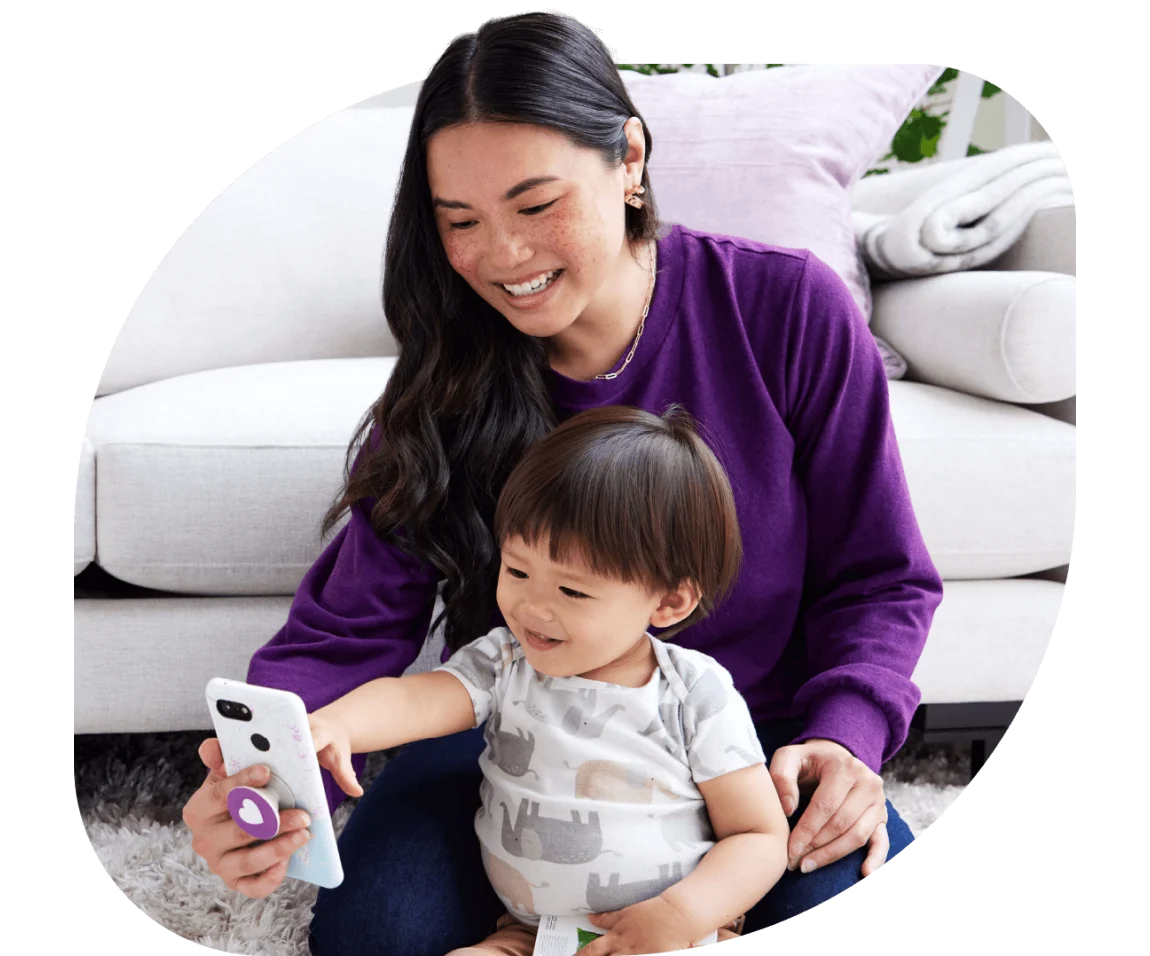 A mother and child interacting with a smartphone