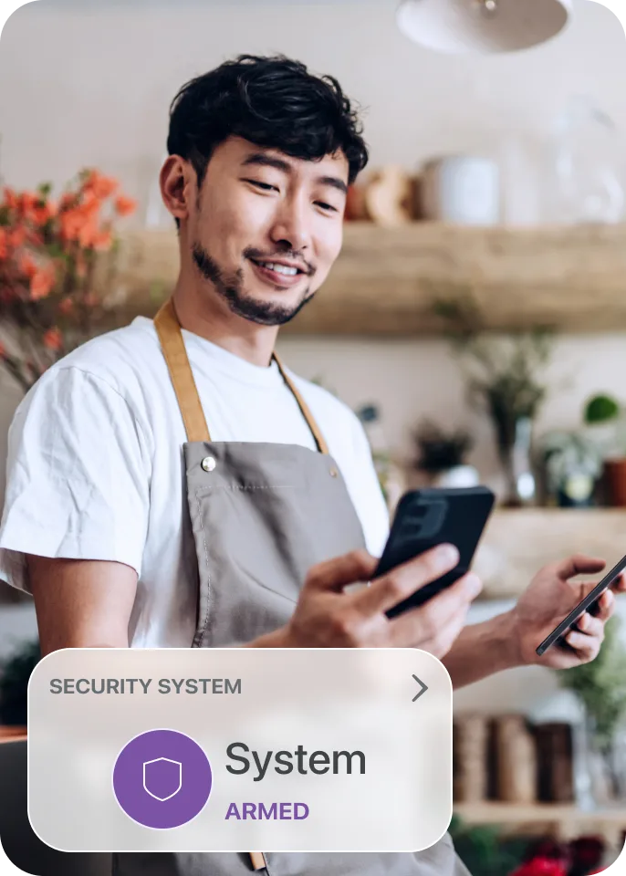 A man on his phone arming his security for his workplace
