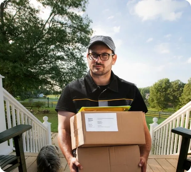 Delivery person holding packages on front porch