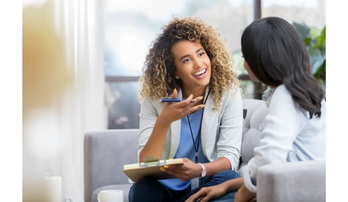 An image showing a doctor talking to a patient in a health care center.