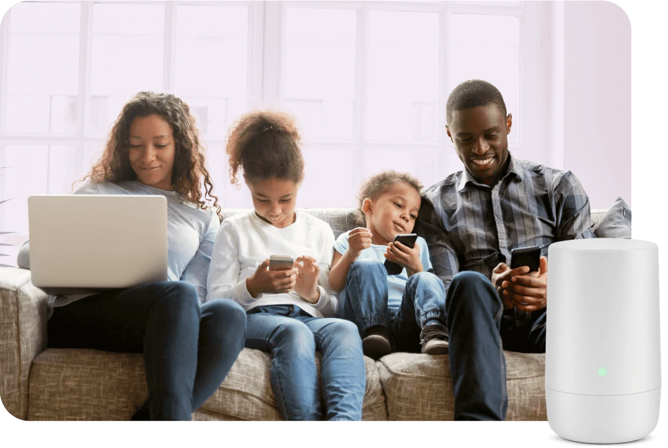 A family of four sits on a couch, smiling and each using a laptop or smartphone connected to fast, reliable TELUS PureFibre X Internet.