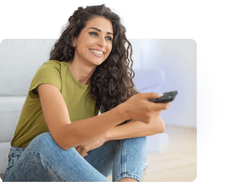 A TELUS Optik TV customer using the new backlit remote