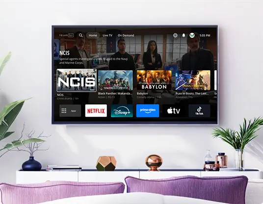 A large TV hangs on a wall displaying the Optik interface