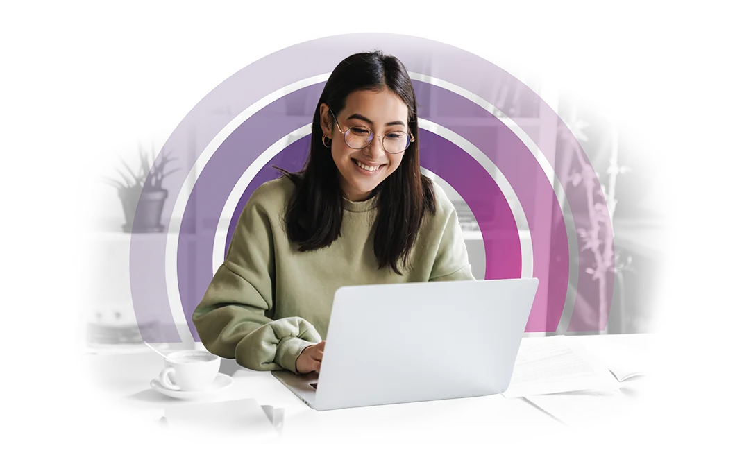 Young woman with glasses smiling and looking at her laptop