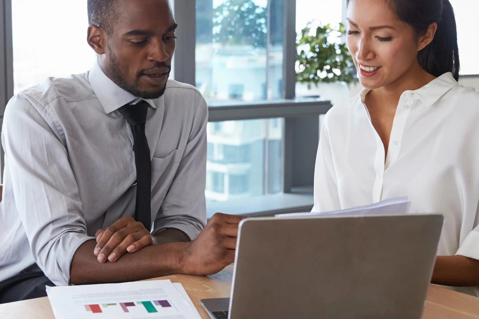 Two HR professionals analyzing employee data